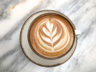 top view cappuccino coffee with latte art on marble table