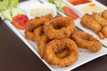 Salt and pepper squid deep-fried or Calamari on a white plate.