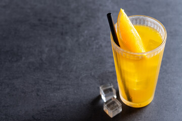 Orange vodka cocktail on black slate background. Copy space.cocktail screwdriver