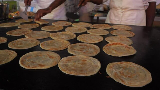 Two man making traditional Malabar parotta - Street food, Indian