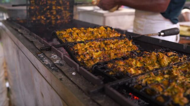 Closeup shot of barbecuing chicken seekh kebab on griller.Grillng roasting