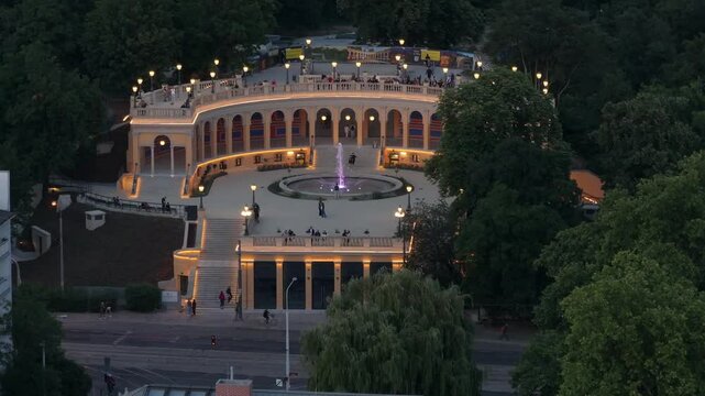Full wide still top shot of Bastion Sakwowy fort in Wroclaw, fountain flowing in the middle of the building, tourists enjoying the attraction.
