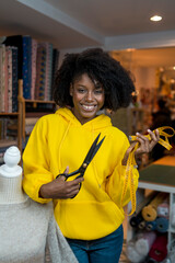 African american girl in her sewing workshop.