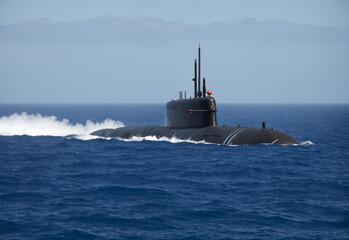Fototapeta premium Generic military nuclear submarine floating in the middle of the ocean while shooting an undersea torpedo missile