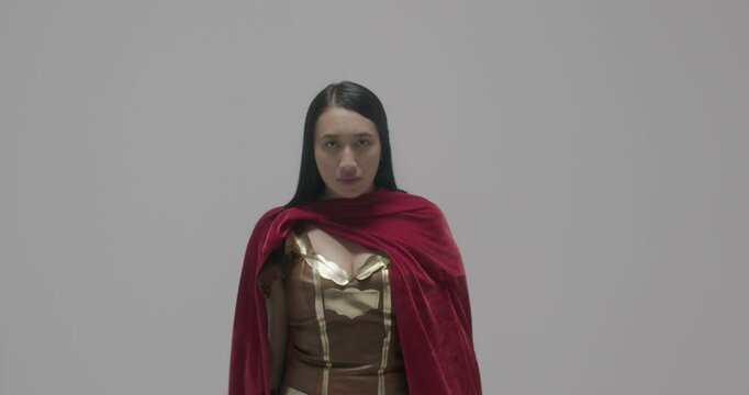 Studio shot of superwoman in Xena hero suit
