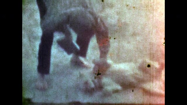 Archive film, man owner stroking happy dog outdoors. Man playing with cute pet friend, scratching belly in summer outside. Animal care friendship. Cheerful owner love. Vintage color movie. Retro 1980s