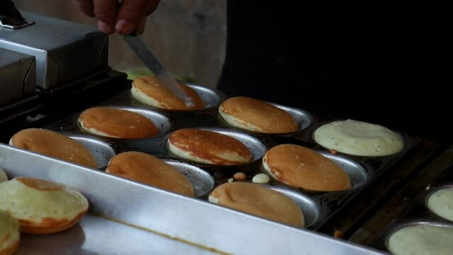 Cooking cubit cake (Kue Cubit). Cubit cake is a street snack that is very liked by children and teenagers in Indonesia