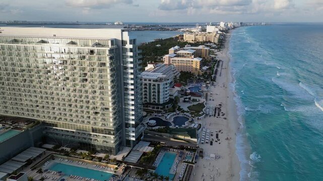 Golden evening sun reflects off glass windows in Cancun resort hotels