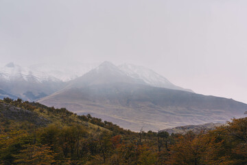 The mountains are covered in snow and the sky is cloudy. The scene is peaceful and serene