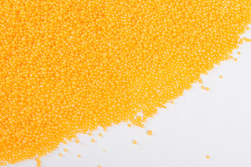 Scattered orange bath pearls, top view