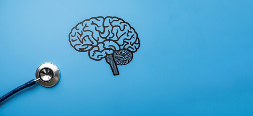 Stethoscope and human brain on blue background, mental health care concept background with copy space
