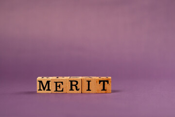 purple warm background with shadows wooden cubes with black letters and laid out words from letters...
