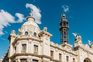 Fototapeta premium Detailed view of an ornate dome and tower on a historic building in Valencia. The architectural elements and clear sky emphasize the city s rich heritage and grandeur.