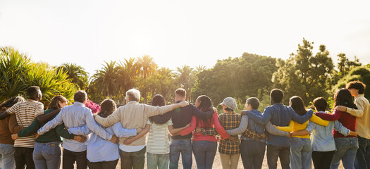 Group of multigenerational people hugging each others - Support, multiracial and diversity concept - Main focus on senior man with white hairs