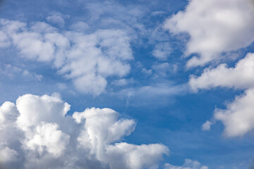 Blue sky background. The clouds on the sky. Colorful blue sky view in bright tones.