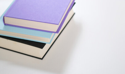 Close up mock up books stack on white table with copy space 
