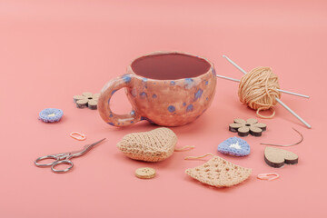 A cup of fragrant hibiscus tea and cute handmade decor. Good mood concept, cozy home comfort