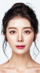 Naklejka premium A beautiful Chinese woman showcasing her healthy skin at a spa, set against a pristine white background.