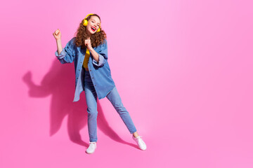 Full length photo of shiny attractive lady dressed denim jacket earphones having fun empty space isolated pink color background