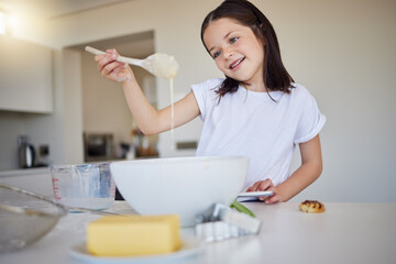 Home, kitchen and kid with mixing for baking, recipe and ingredients for child development with learning. House, counter and girl with dessert, pastry and breakfast preparation in bowl with spoon