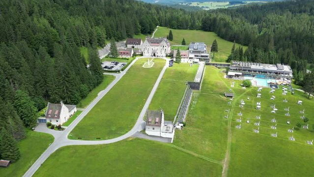 Das Kranzbach resort hotel 5 stars aerial circling drone shot bavaria german alps forest green grass fields sunshine