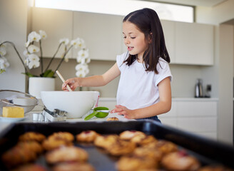 Home, kitchen and girl with mixing for baking, recipe and ingredients for child development with learning. House, counter and kid with dessert, pastry and breakfast preparation in bowl with spoon