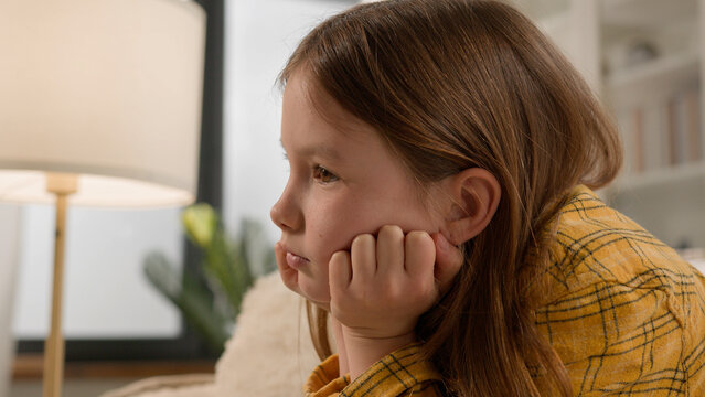 Frustrated pensive bored Caucasian girl child punished for bad grades at school suffering alone abused at home. Exhausted daughter schoolgirl little kid feel tired sorrowful sad custody stress crisis