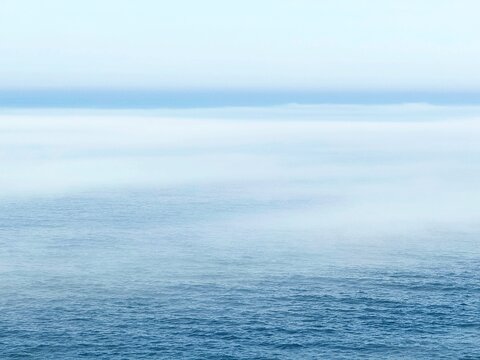 Fog mist above blue sea water
