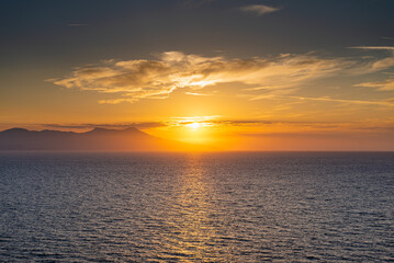 Sunset in the sea on the horizon of the mountain