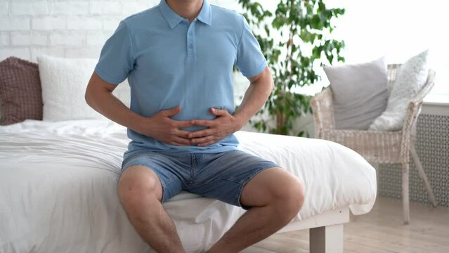 Stomach ulcer, man with abdominal pain suffering at home, symptoms of gastritis, diseases of the digestive system, health problems concept