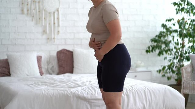 Menstrual pain, woman with stomachache suffering from pms at home, endometriosis, cystitis and other diseases of the urinary system