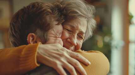 Happy affectionate elderly mom meeting son at home with hug, embracing adult child with closed eyes, feeling love, tenderness, gratitude. Mature mother casual portrait