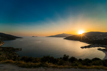 The view of the setting sun after the magnificent sea and mountains accompanied by sunset.