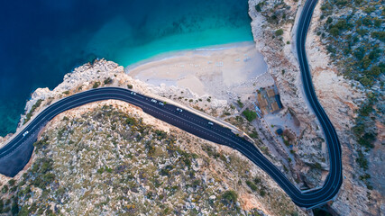 Aerial view of Kaputaş beach from drone. A beautifully winding road along the Mediterranean coast. A wonderful beach with white sand and blue water.