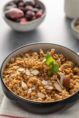 Crispy homemade granola with sliced almonds in a bowl. Healthy food