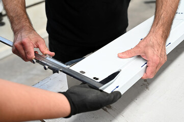 Employee taking measurements in the factory