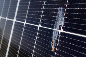 Dirty solar panels on a well-exposed wall of an individual house, making savings following the...