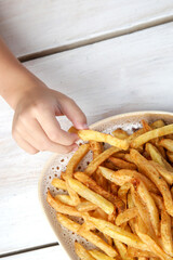 Little girl is eating french fries