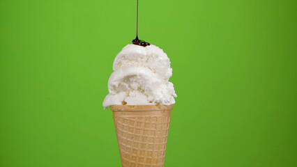 Vanilla ice cream cone with chocolate syrup