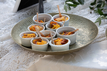 Round tray presenting small bowls of hors d'oeuvres at a party