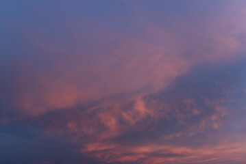 Pink clouds on the sky at sunset. Evening sky texture, abstract nature background