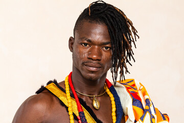 African man wearing traditional clothing posing on white background