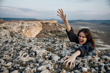 empowered woman climbing towards the sky on a mountain peak