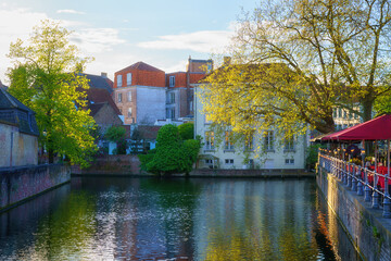 Fototapeta premium Old Town of Bruges, Belgium, famous landmark. Scenic cityscape with medieval historical buildings along the Groenerei canal at sunset, outdoor travel background