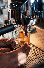 coffee machine a cup of coffee and human hands