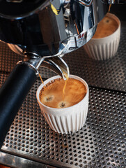 pouring cappuccino at the cafe coffee machine