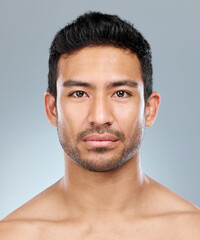Obraz premium Beauty, grooming and portrait of masculine man in studio on gray background for cosmetic wellness. Dermatology, natural and skincare with face of confident person in bathroom for hydration or hygiene