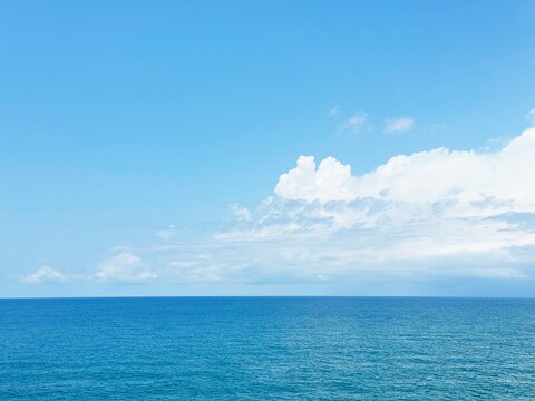 Beautiful white cloud above calm blue sea