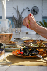 Young woman having dinner, Mussels in the Mediterranean restaurant. 