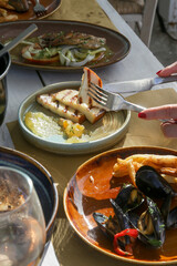 Woman is eating Grilled Talagani cheese in the restaurant